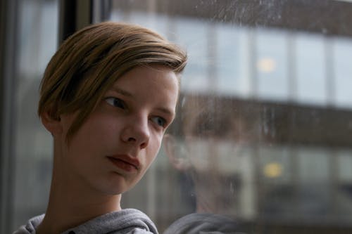 Boy Leaning On Glass