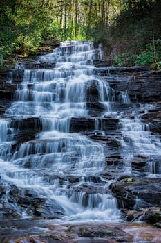 Breathtaking view of Minnehaha Falls cascading over rocks in a lush forest setting, Georgia, USA.