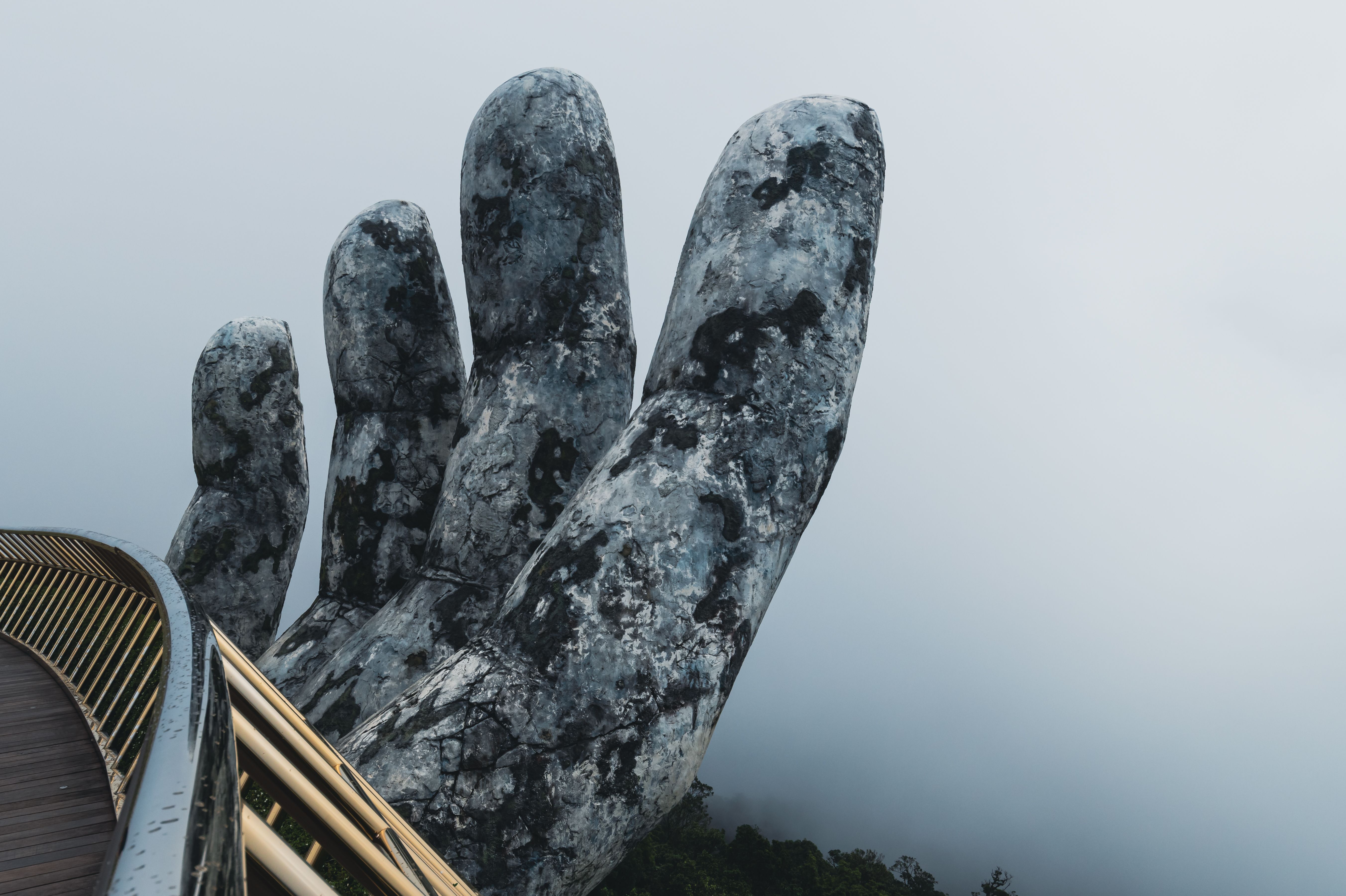 golden bridge ba na hills giant stone hands vietnam blue sky