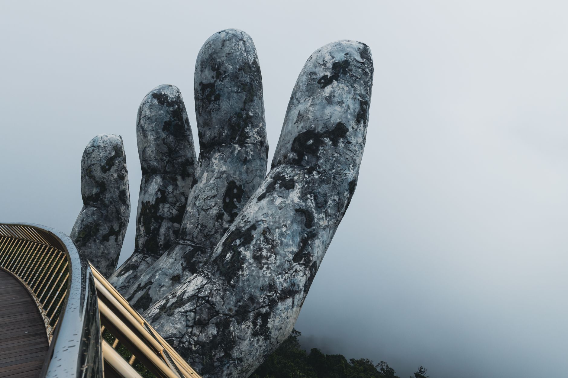 golden bridge ba na hills giant stone hands vietnam blue sky