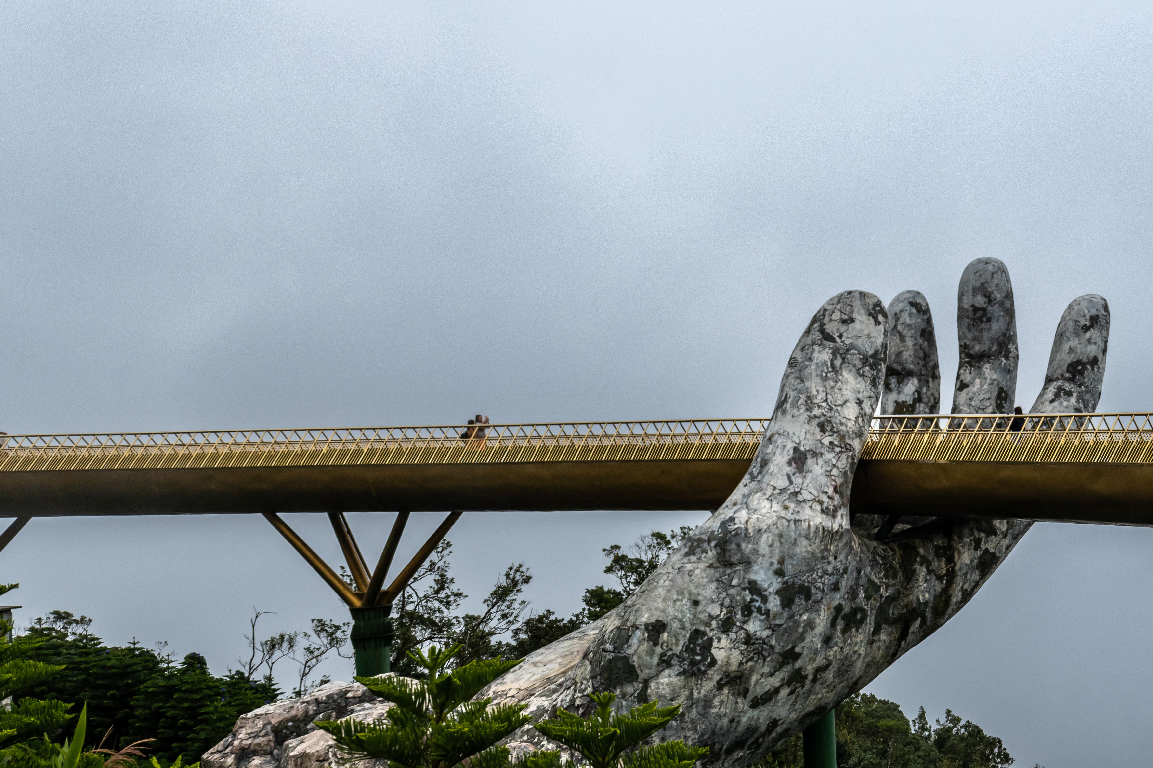 Dramatic view of the iconic Golden Hand Bridge in Da Nang, Vietnam.
