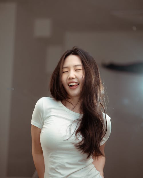 A woman in a white shirt smiling