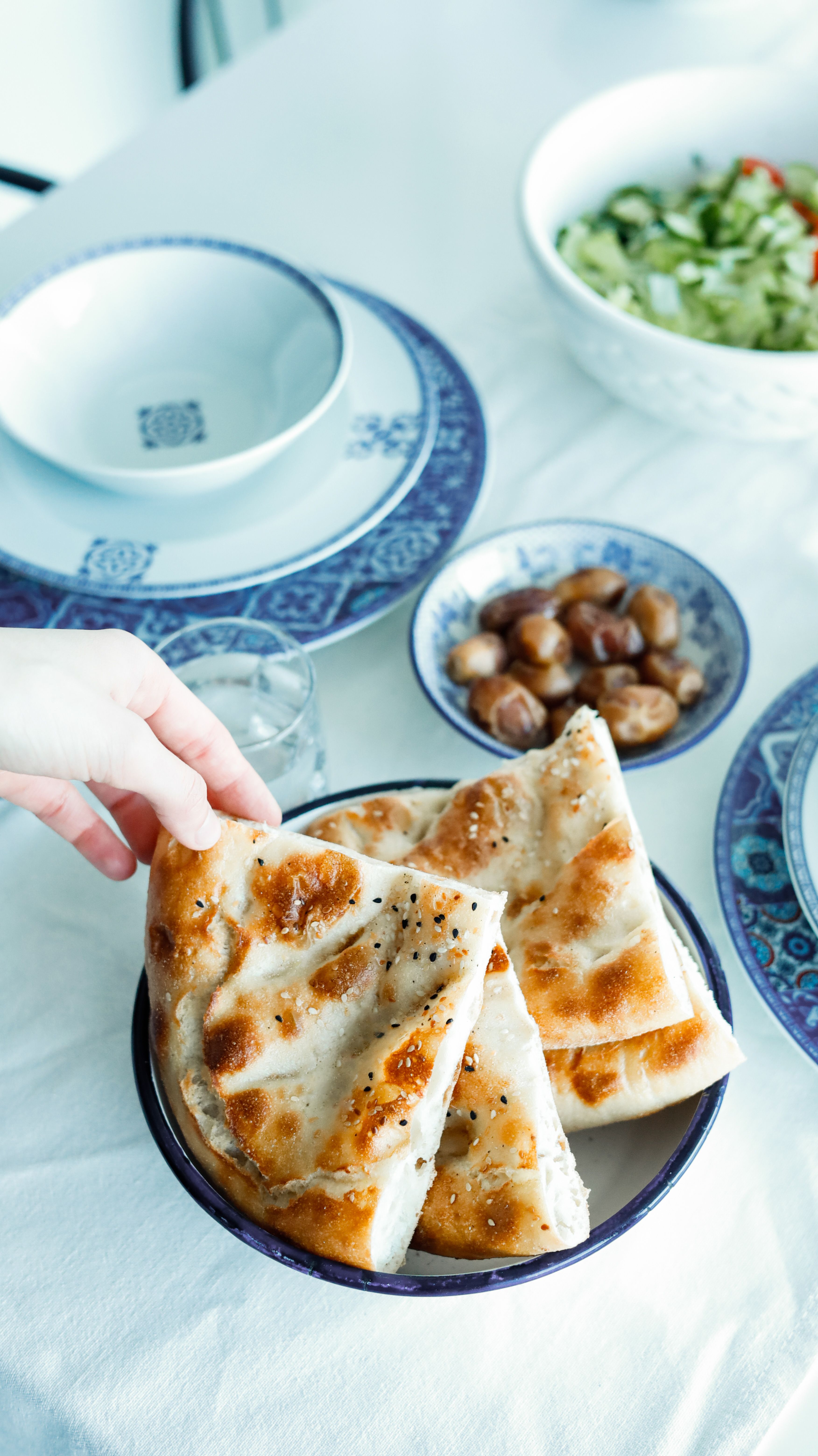 Soft, pillowy homemade naan leavened with yeast and yogurt, cooked in a hot skillet and brushed with garlic butter.