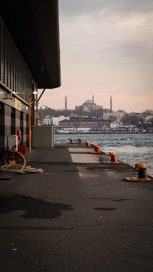 A man is sitting on a bench near the water