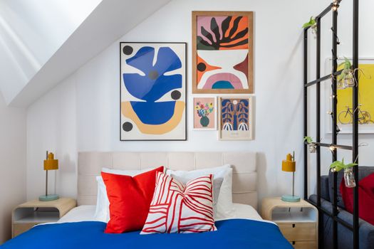 Contemporary bedroom in Prague featuring bold art and colorful decor for a stylish look.