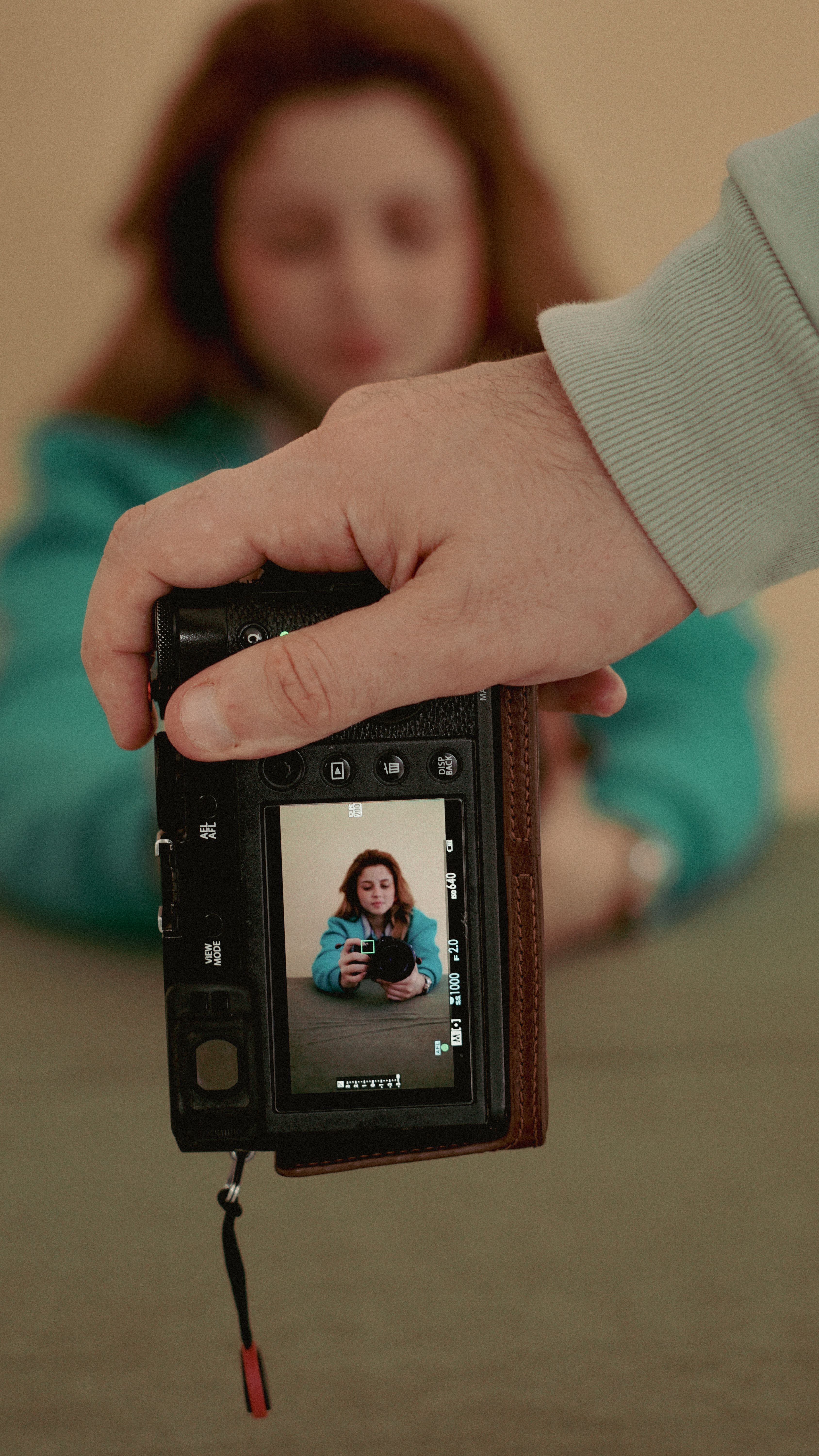 Focus on capturing a creative reflection of a woman using a mirrorless camera.