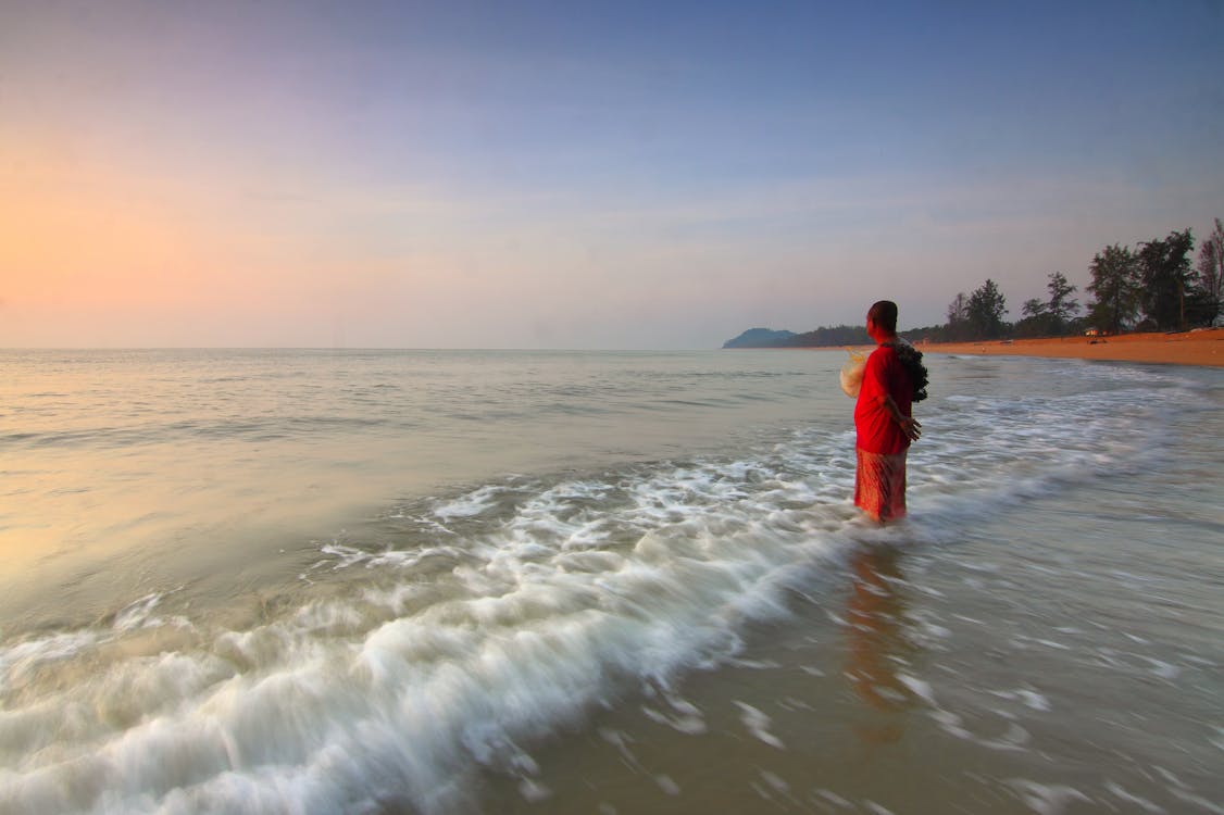 Free Person on the Seashore during Sun Set Stock Photo