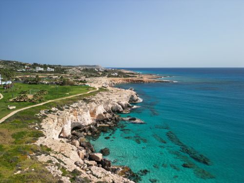 Free A breathtaking aerial view of Ayia Napa's rocky coastline and crystal-clear turquoise waters. Stock Photo
