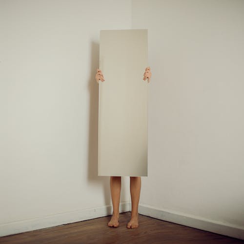 Free Woman Behind a Mirror in a Room  Stock Photo