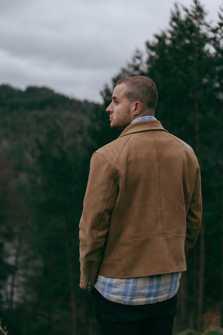 Fashionable Man In A Checkered Shirt And Brown Jacket Standing Outside 