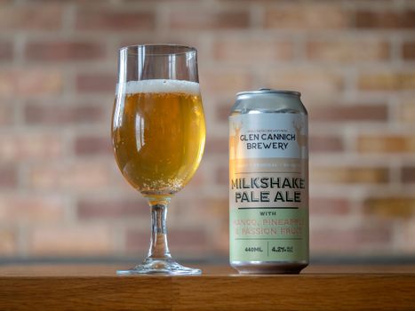 Glass and can of Glen Cannich Milkshake Pale Ale with mango, pineapple, passion fruit flavor.