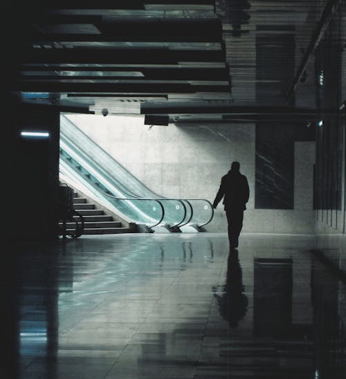 Subway Escalator and a Silhouette of a Man