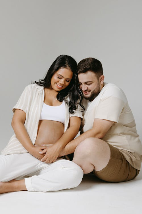 Couple Expecting a Baby Posing in a Studio 