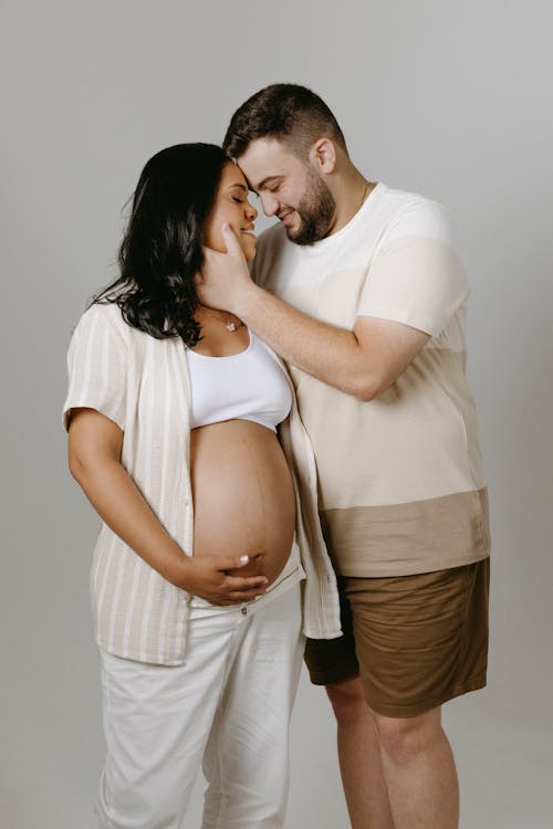 Couple Expecting a Baby Posing in a Studio 