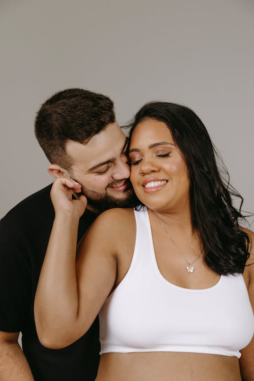 Couple Expecting a Baby Posing in a Studio 