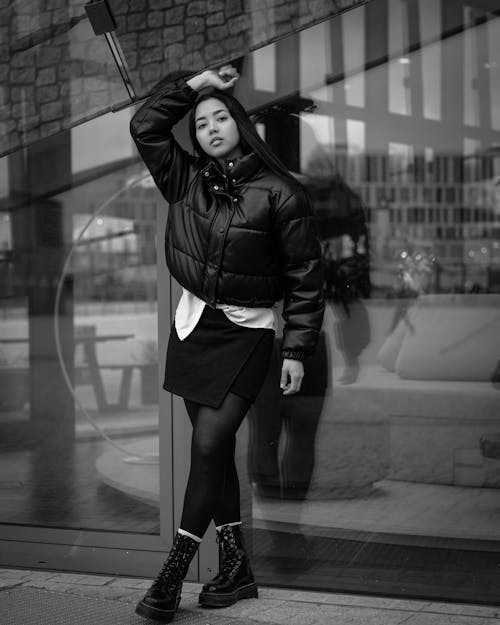 Brunette Woman in Puffer Jacket Posing on Sidewalk