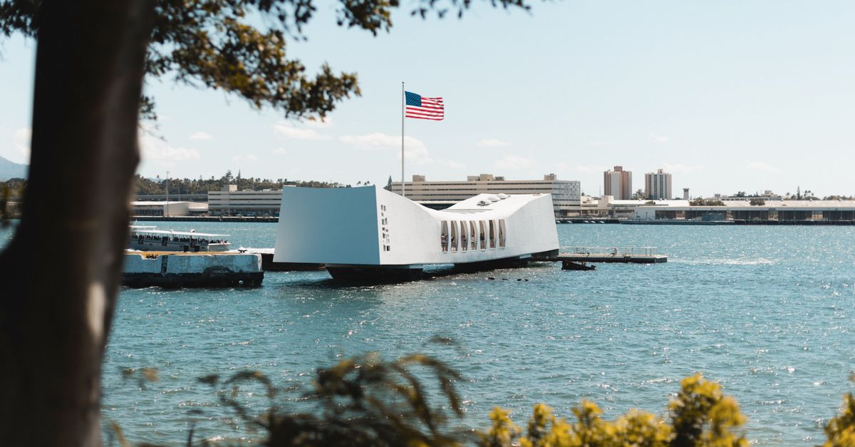 The USS Arizona Memorial over Pearl Harbor waters, a tribute to WWII history in Honolulu, Hawaii.