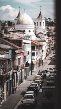 Stunning cityscape of Cuenca, Ecuador, featuring historic church domes and vibrant street life.