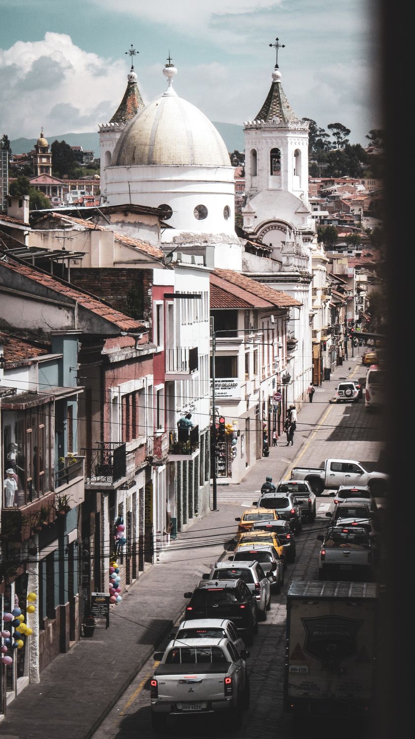 Stunning cityscape of Cuenca, Ecuador, featuring historic church domes and vibrant street life