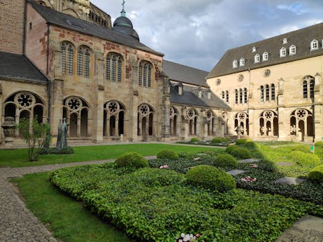 Beautiful courtyard garden of historic Trier Cathedral in Germany, a serene architectural landmark.