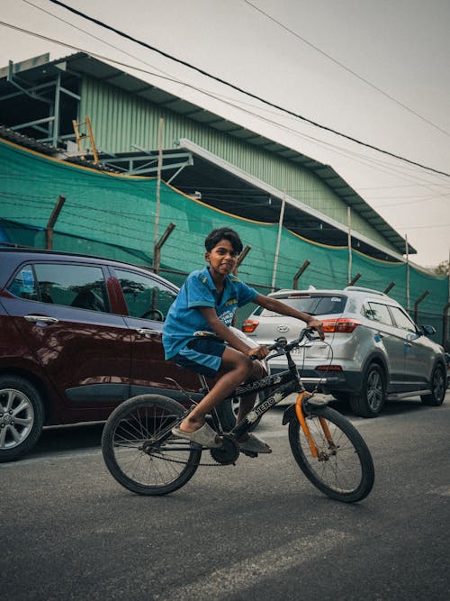 A boy riding a bike on the street