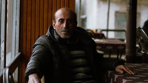 Elderly Man Sitting at Cafe