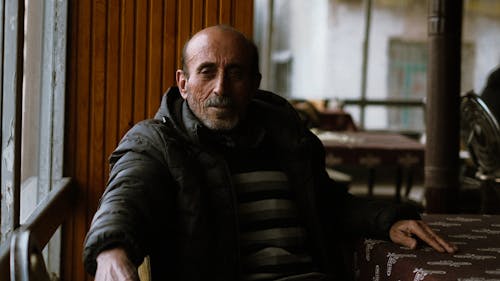 A man sitting at a table in a restaurant