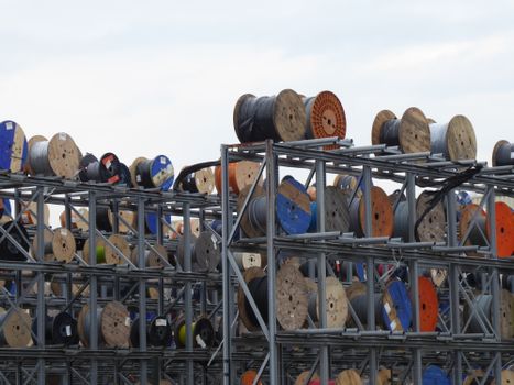 Colorful industrial cable reels stacked outdoors in Alphen aan den Rijn.