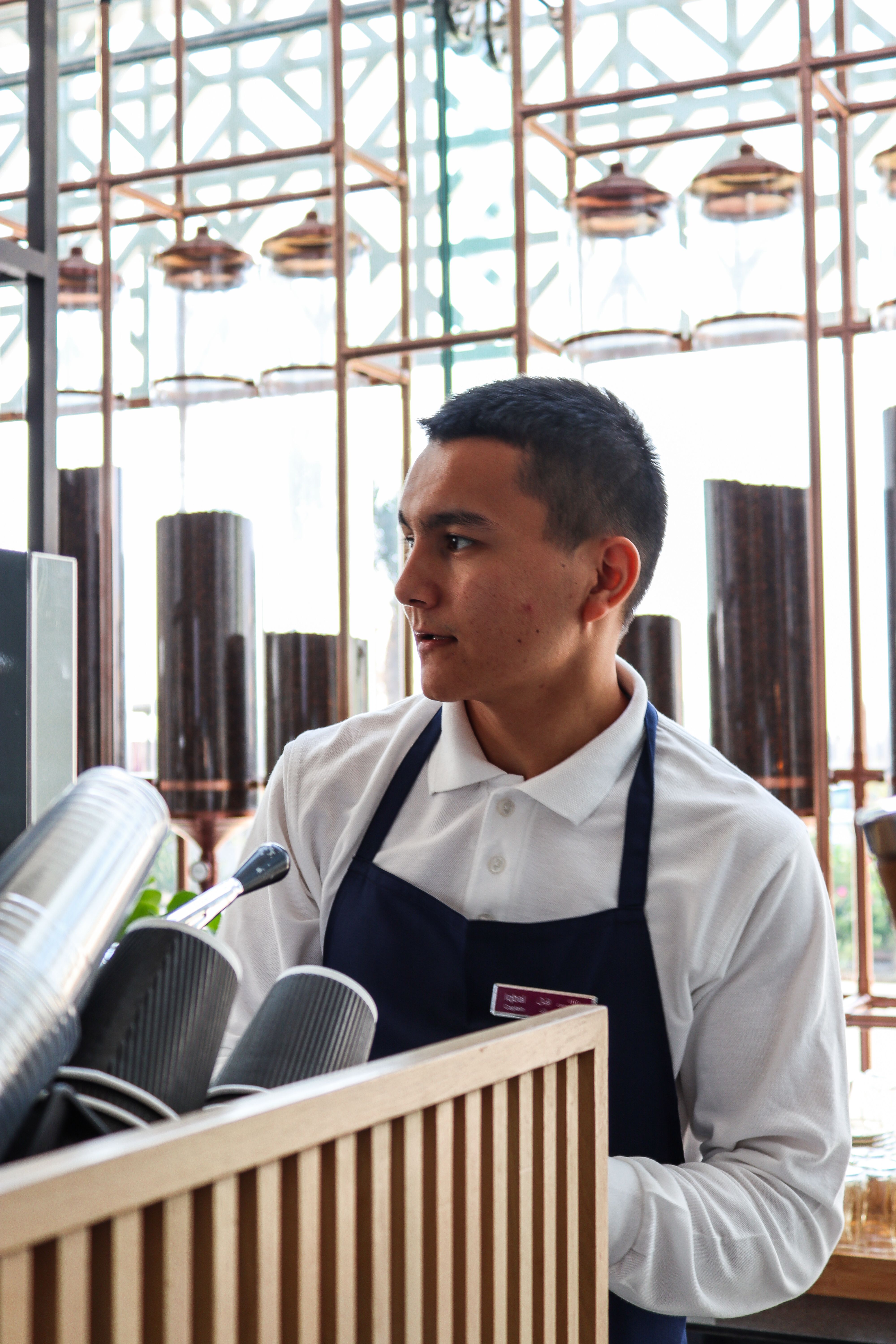 Portrait of Lukas Wagner, head roaster, in an apron at the roastery