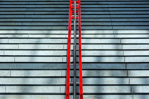 A red ladder on the steps of a building