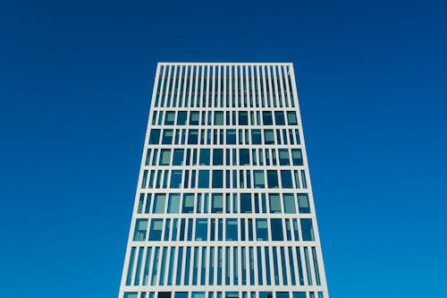 A tall building with windows against a blue sky