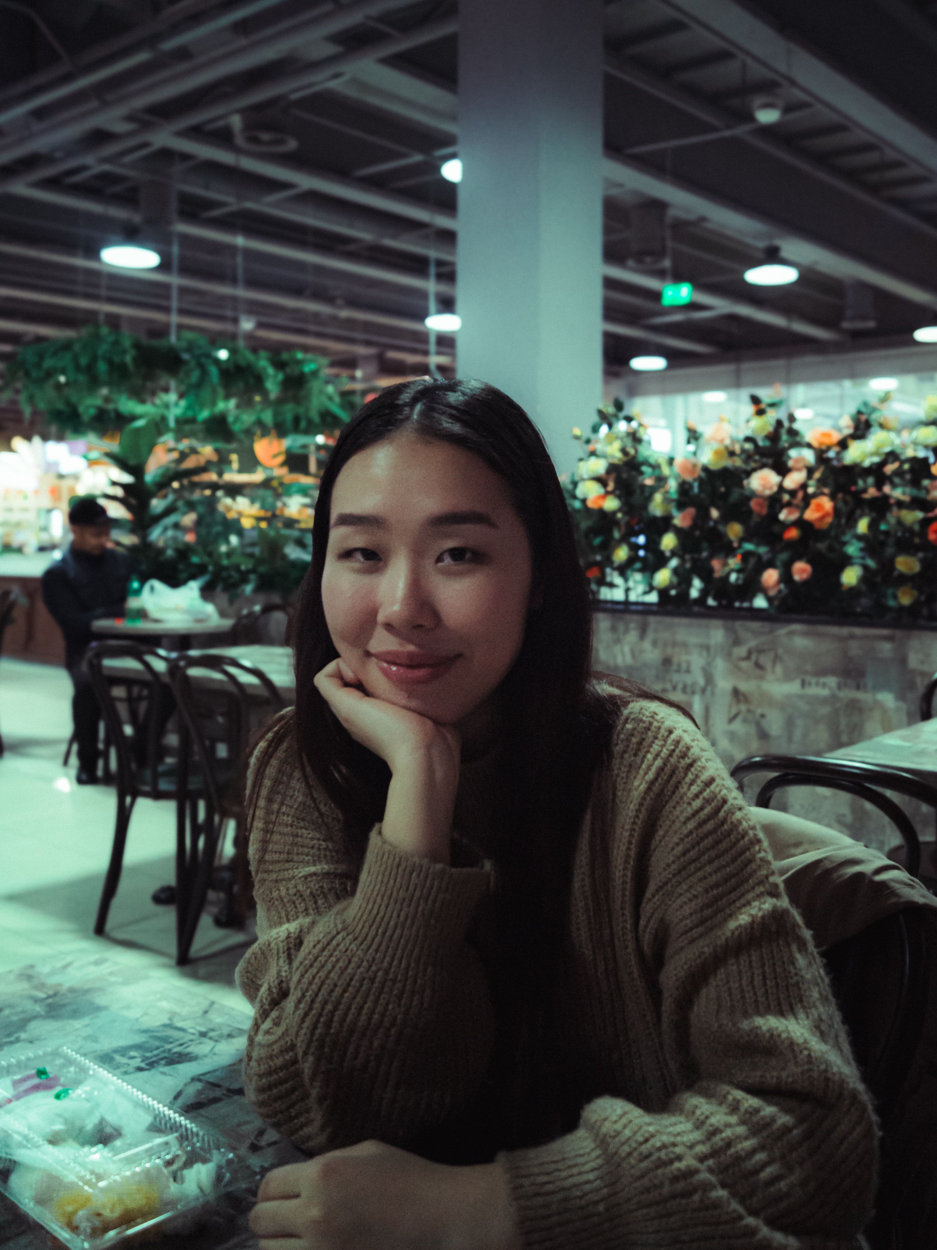 Portrait of Woman Sitting with Hand on Chin · Free Stock Photo