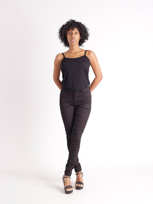A woman in black pants and a tank top