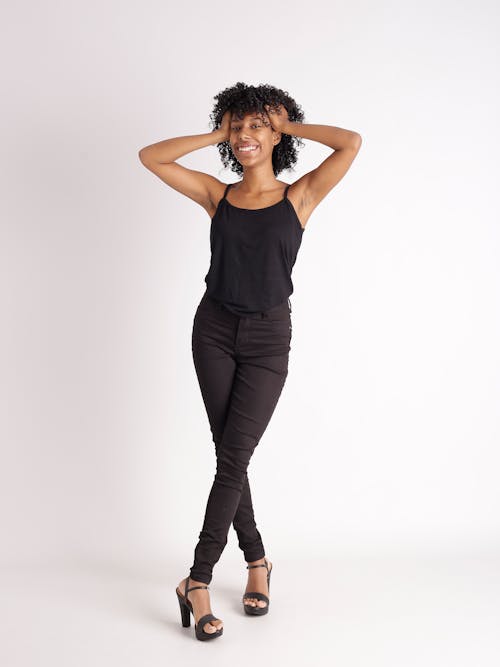 A woman in black tank top and black pants