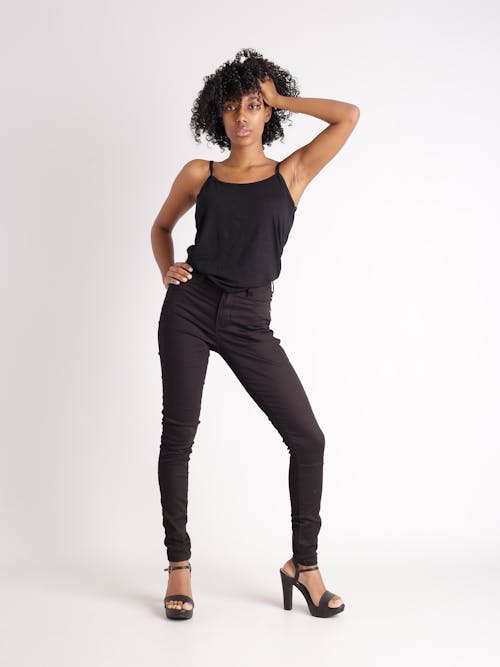 A woman in black tank top and black jeans