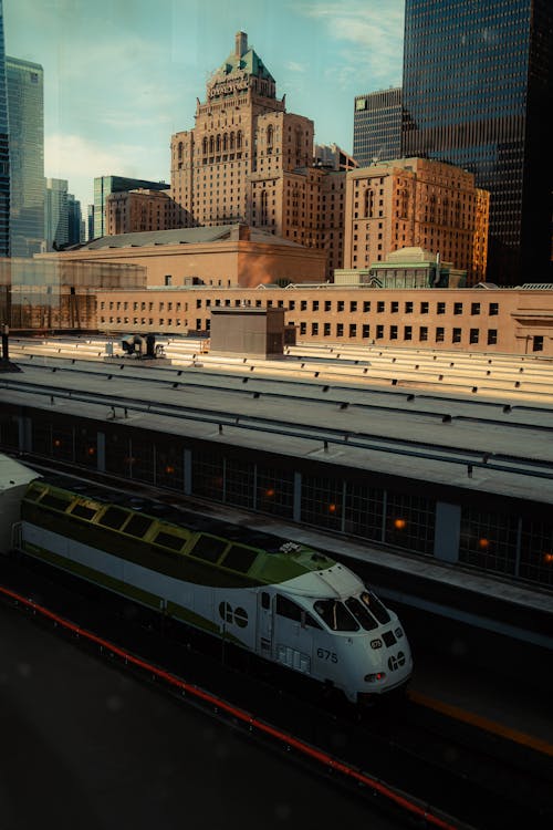 A train is passing by a city skyline