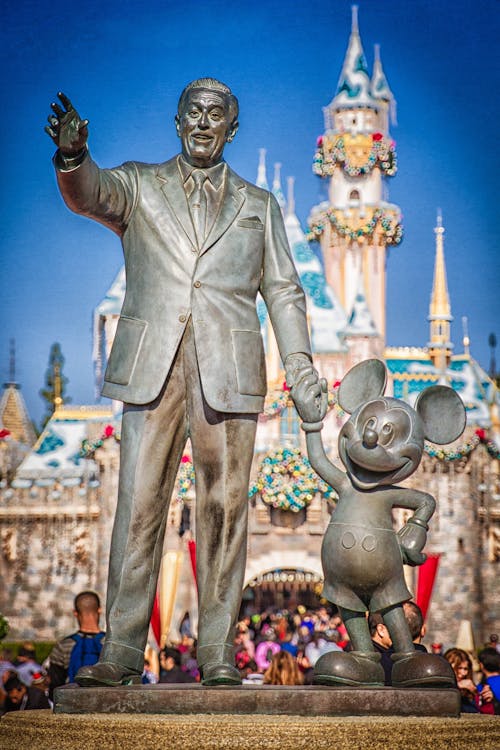 A statue of walt disney and mickey mouse