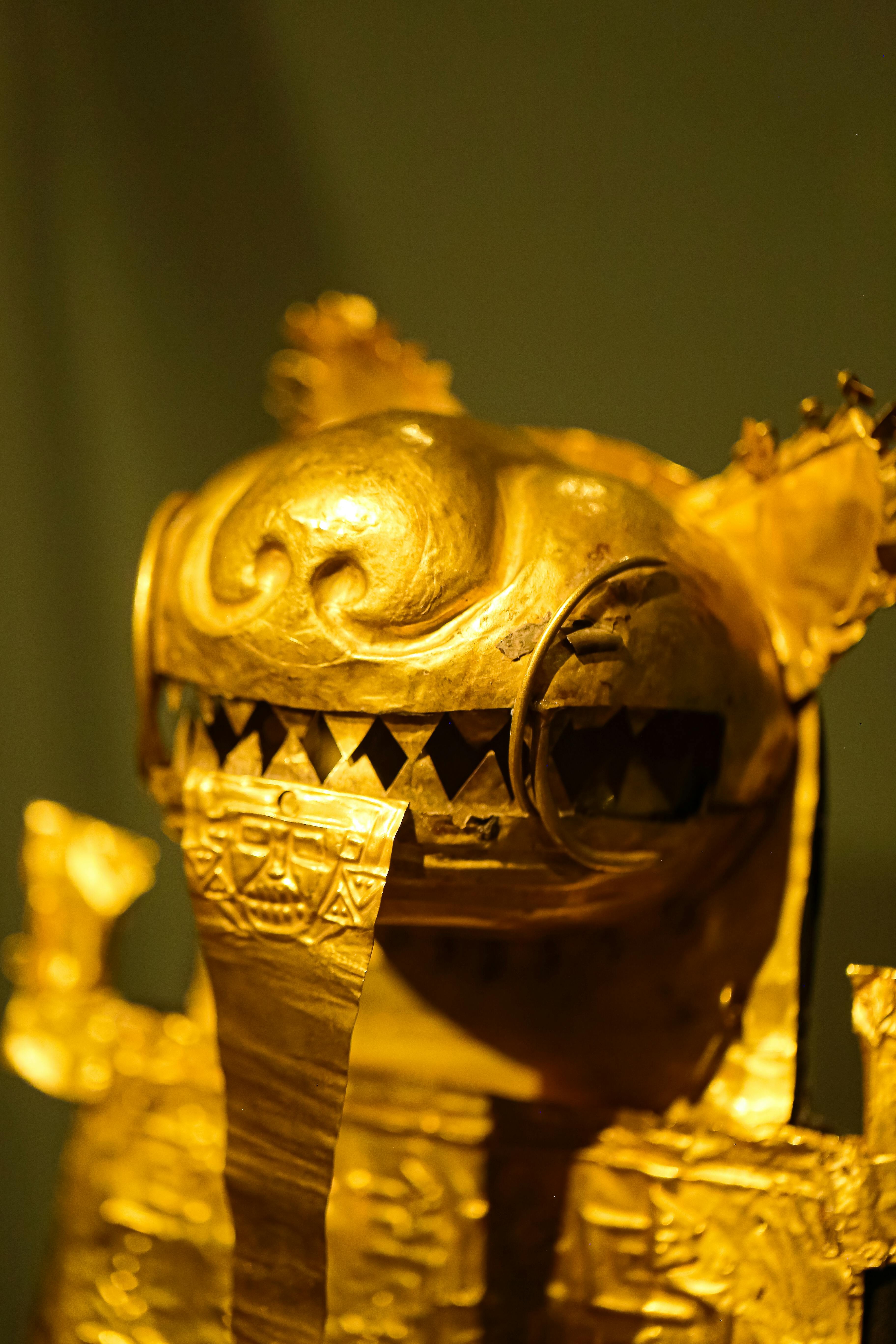 golden ancient statue in a museum