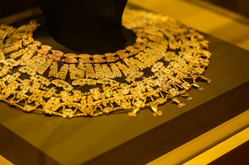 A gold necklace on display in a museum