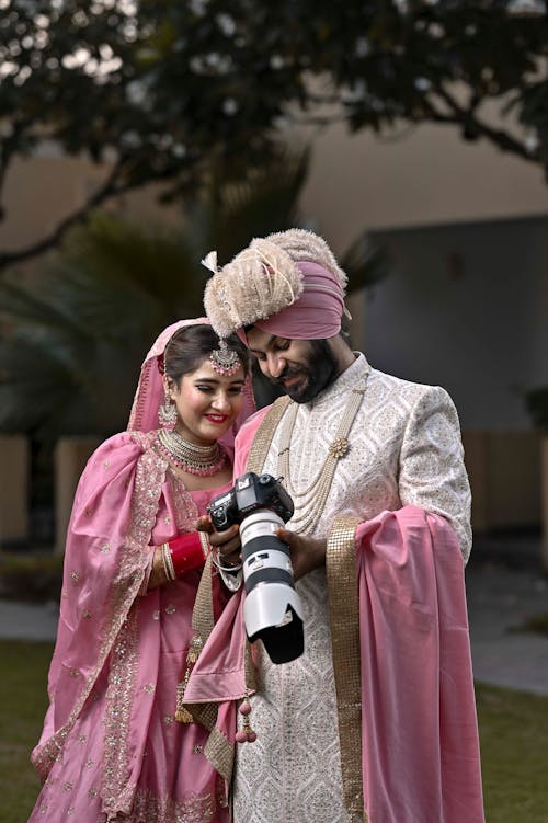 A man and woman in traditional attire posing for a photo