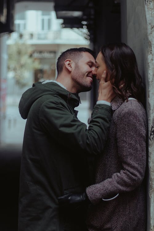 Happy Couple Kissing in Alley in Town