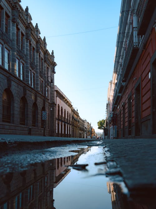 A puddle on the street in a city