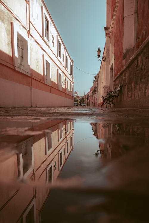 A reflection of a building in a puddle