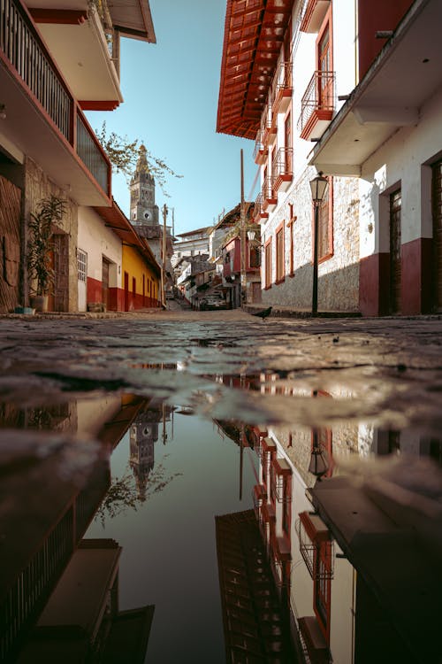 A reflection of a street in a puddle