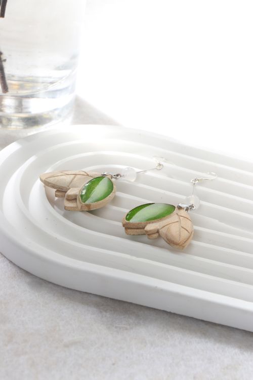 Free Minimalist wooden and green stone earrings elegantly displayed on a white tray. Stock Photo