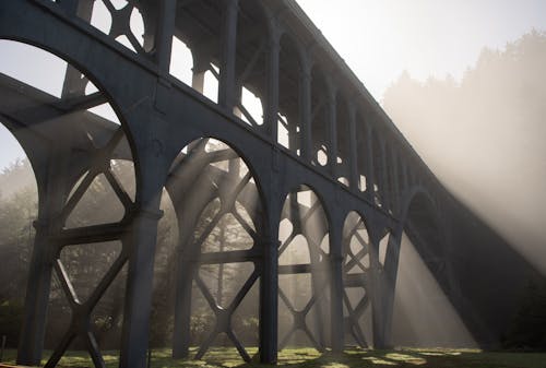 A bridge with sun rays shining through it