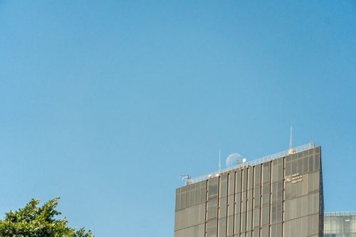 Free Office building in Mexico City with a clear blue sky background, capturing urban architecture. Stock Photo