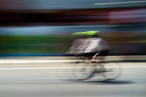 A blurry image of a person riding a bike