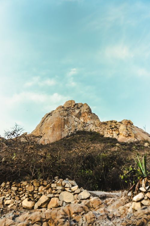Free Scenic view of the prominent Peña de Bernal monolith rock under a clear sky in Mexico. Stock Photo