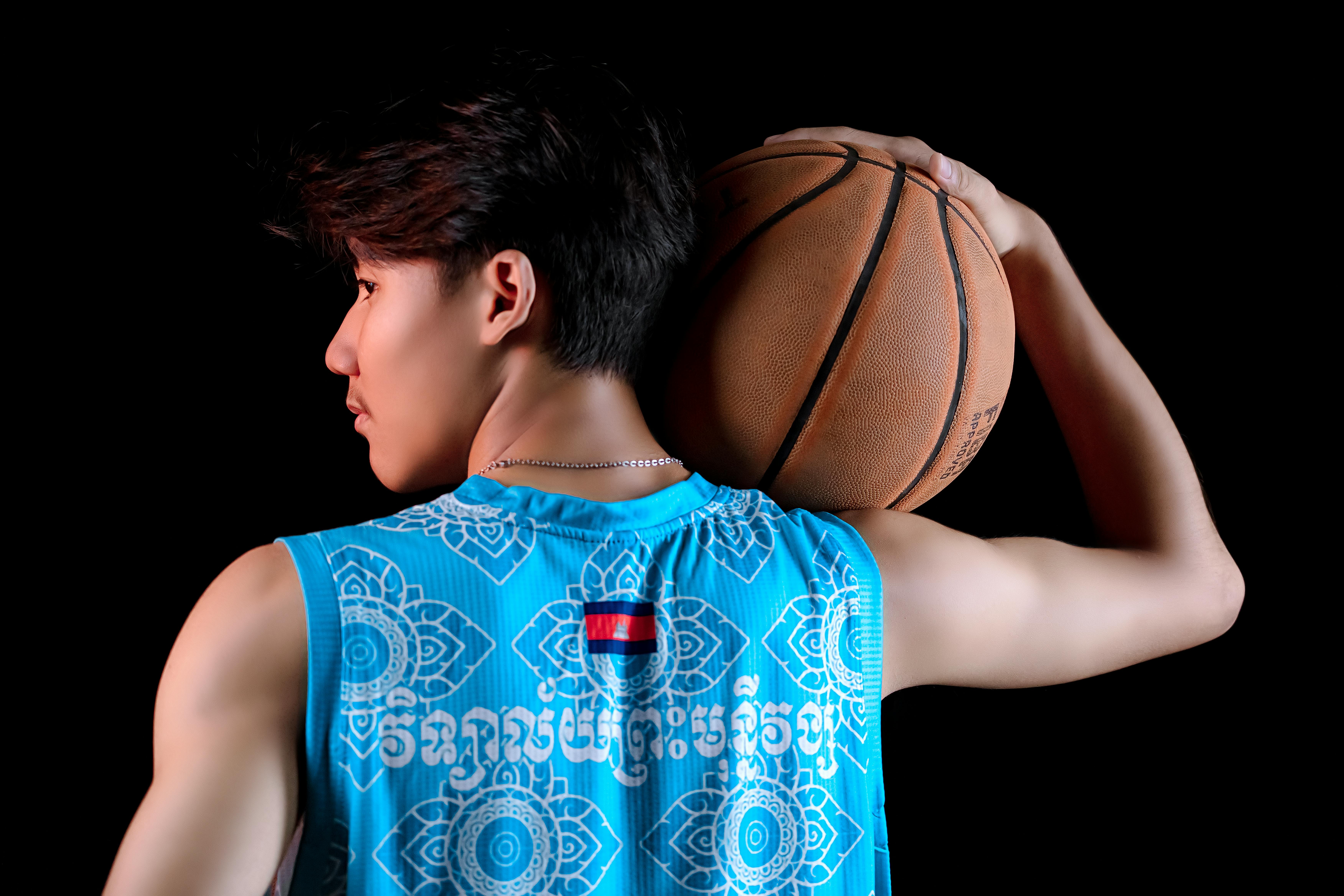 muscular player with basketball